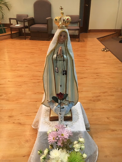Our Lady of Fatima - located to the right of the altar table.