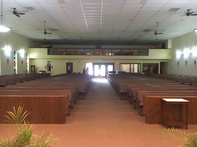 View from behind the altar to the back of church with the balcony above.